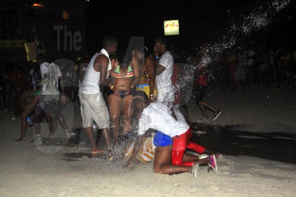 Anthony Minott/Freelance Photographer
Patrons are drenched with water during Double Shotts xtreme wet and dry at Sugarman's Beach, Hellshire, Portmore, St Catherine last Sunday.
