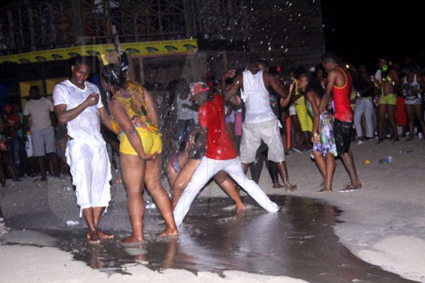 Anthony Minott/Freelance Photographer 
Patrons dance in the wet area during Double Shotts xtreme wet and dry at Surgarman's Beach, Hellshire, Portmore, St Catherine last Sunday.
