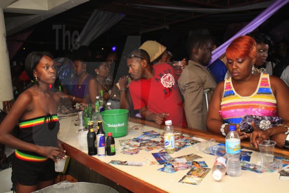 Anthony Minott/Freelance Photographer
Patrons order from the bar during Kelly Upsetter's "Drink Up" under the theme: "Who owns the Bar", on the roof of Twyn City Restaurant and Lounge, Port Henderson Road, Portmore, St Catherine last Saturday.