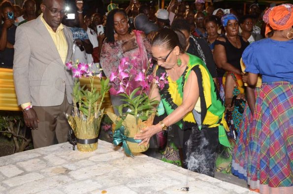 Shorn Hector/Photographer  Minister of Labour and Social Security, Shahine Robinson lays a floweral arrange on the tomb of Africans who are buried on site at the Seville Emancipation Jubilee 2018