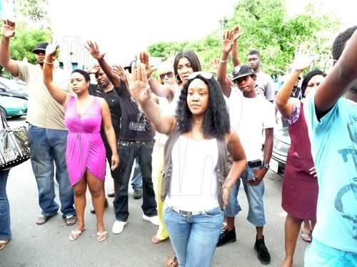 Krista Henry Photo

Entertainers Timberlee, D' Angel and Tifa among a group of supporters at the vigil for Oneil Edwards at the Kingston Public Hospital, yesterday.