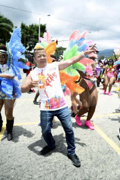 Gladstone Taylor<\n>Brian 'Ribbie' Chung  shares the lightining bolt pose with our lens as he joined the revellers in yesterday's road march.