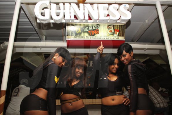 Anthony Minott/Freelance Photographer 
The Guinness girls take a photo opt during his party and customer appreciation day atop the roof of Ken's Wildflower Sports bar, Port Henderson Road, Portmore, St Catherine on Tuesday, March 13, 2012. Hundreds of patrons came to give their support.