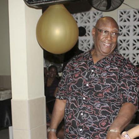 Anthony Minott/Freelance Photographer
Birthday boy, Lester Crooks, aka, 'Father Ken' cuts his birthday cake with his princess Kelly Elliot during Portmore businessman, Lester "Ken' Crooks birthnight party and customer appreciation day atop the roof of Ken's Wildflower Sports bar, Port Henderson Road, Portmore, St Catherine on Tuesday, March 13, 2012. Hundreds of patrons came to give their support.