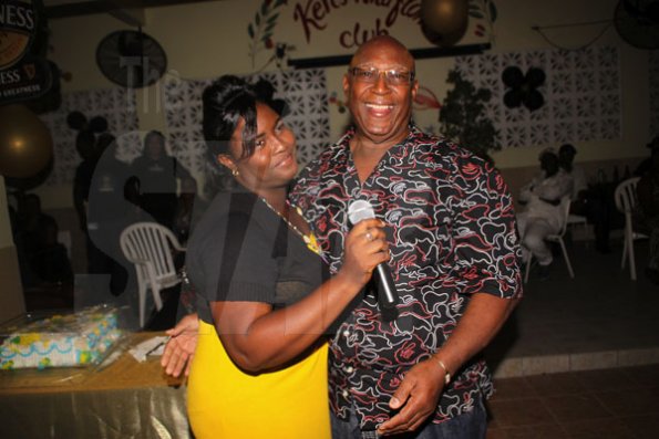 Anthony Minott/Freelance Photographer
Birthday boy, Lester 'ken' Crooks, pose with a female patron during hs birthnight party atop the roof of Ken's Wildflower Sports bar, Port Henderson Road, Portmore, St Catherine on Tuesday, March 13, 2012. Hundreds of patrons came to give their support.