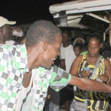 Anthony Minott/Freelance Photographer
This couple swing to a rock and roll tune during Portmore businessman, Lester "Ken' Crooks birthnight party atop the roof of Ken's Wildflower Sports bar, Port Henderson Road, Portmore, St Catherine on Tuesday, March 13, 2012. Hundreds of patrons came to give their support.