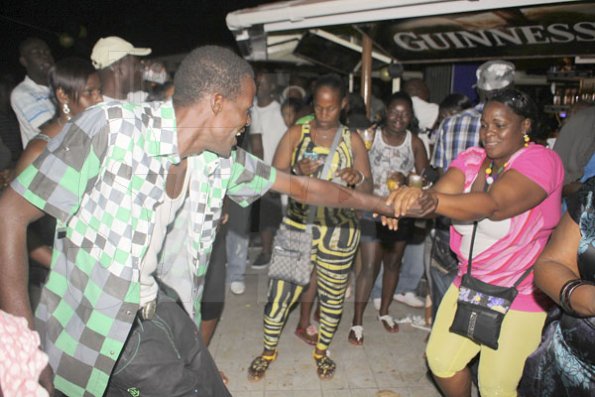 Anthony Minott/Freelance Photographer
This couple swing to a rock and roll tune during Portmore businessman, Lester "Ken' Crooks birthnight party atop the roof of Ken's Wildflower Sports bar, Port Henderson Road, Portmore, St Catherine on Tuesday, March 13, 2012. Hundreds of patrons came to give their support.