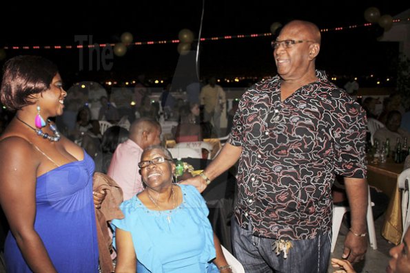 Anthony Minott/Freelance Photographer
Birthday boy, Lester 'Ken' Crooks (right), greets a few of his patrons during his birthnight party and customer appreciation day atop the roof of Ken's Wildflower Sports bar, Port Henderson Road, Portmore, St Catherine on Tuesday, March 13, 2012. Hundreds of patrons came to give their support.