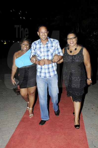Winston Sill/Freelance Photographer
The Gleaner's Managing Director Christopher Barnes is escorted into the party venue by Keisha Shakespeare-Blackmore (left) and Barbara Ellington.

*************************************************************Flairtatious party held at Guardsman Group on Saturday October 22, 2011.