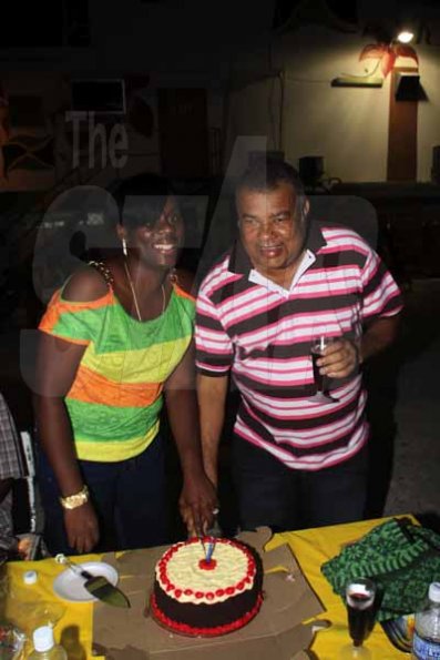 Anthony Minott/Freelance Photographer
Birthday boy,  Lenworth Fulton (right), the Executive Director of Jamaica 4H Club, and his wife Alicia cut the birthday cake, during a party held at Ken's Wildflower Sports Bar and Lounge, Port Henderson Road, Portmore, St Catherine, on Tuesday, September 4, 2012.