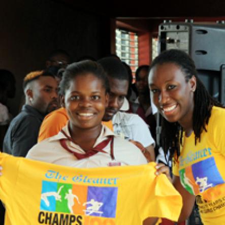 Photo by Sheena Gayle 

Rolaine Miller (left), a student of Herbert Morrison Technical High School in Montego Bay, St. James is all smiles as she receives her prize from The Gleaner's Kerry-Ann  Hepburn (right) during The Gleaner's Champ 100 Tour at the school last Friday.