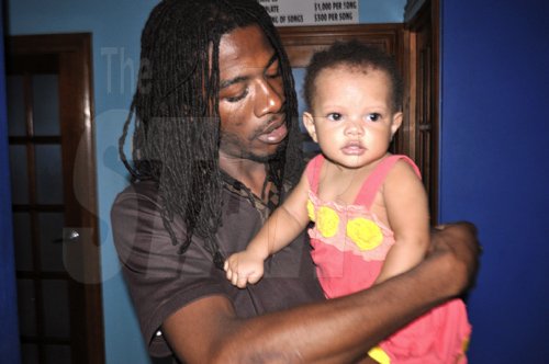 Gyptian holds his 8 month old daughter while at Flava Squad studio on Wednesday