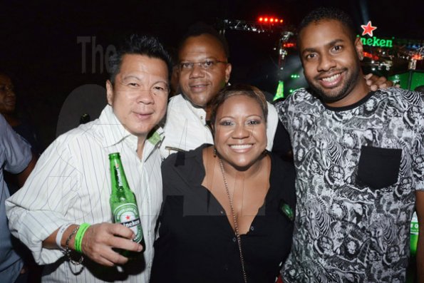 Winston Sill/Freelance Photographer
Red Stripe prsents Heineken World Premiere Party, held at  Fort Rocky, Port Royal on Saturday night November 22, 2014. Here are Brian "Ribbie" Chung (left); Don Creary (second left);  Nasha Douglas (centre), Heineken Brand Manager; and Kamal  Bankay (right).