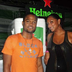 Contributed                                                                                                                                                             Imru James, Assistant Brand Manager Heineken relaxes with Marika Wholas after presenting her with the Heineken branded igloo packed with beer which she won at Heineken Igloo on Monday October 17th at the Ocho Rios Bay Beach.
