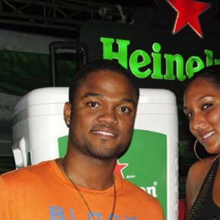 Contributed                                                                                                                                                             Imru James, Assistant Brand Manager Heineken relaxes with Marika Wholas after presenting her with the Heineken branded igloo packed with beer which she won at Heineken Igloo on Monday October 17th at the Ocho Rios Bay Beach.