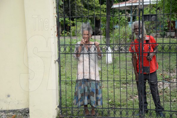 Jermaine Barnaby/Freelance PhotographerThese two senior citizens take a peek s at Jamaica carnival road march on Sunday April 23, 2017 while they travelled along Hope road.