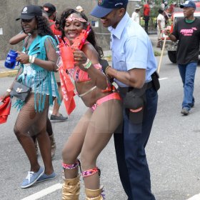 Jermaine Barnaby/Freelance PhotographerA reveller busing a dance on a police officer at Jamaica carnival road march on Sunday April 23, 2017.