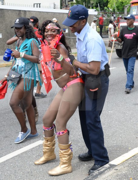 Jermaine Barnaby/Freelance PhotographerA reveller busing a dance on a police officer at Jamaica carnival road march on Sunday April 23, 2017.