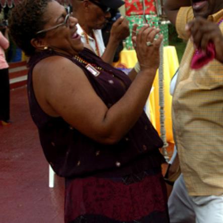 Winston Sill / Freelance Photographer
JPS' Kathy Cooke has Rodger Hutchinson holding on for dear life. 

Jamaica Public Service Company (JPS) Corporate Commu ication Team host Media Christmas Party, held at Norbrook Drive, Norbrook on Sunday November 22, 2009.