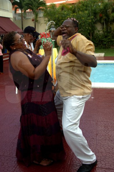 Winston Sill / Freelance Photographer
JPS' Kathy Cooke has Rodger Hutchinson holding on for dear life. 

Jamaica Public Service Company (JPS) Corporate Commu ication Team host Media Christmas Party, held at Norbrook Drive, Norbrook on Sunday November 22, 2009.