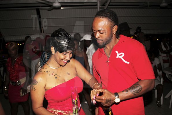 Anthony Minott/Freelance Photographer
ENGAGEMENT:  Sean Picart (right) took the occasion to slip on an engagement ring on his 'heart beat' Pamella McKenzie during Ken's Wildflower Valentine's Night party atop the roof of Ken's Wildflower Restaurant and Lounge, Port Henderson Road, Portmore Plaza, Tuesday, February 14, 2012.
