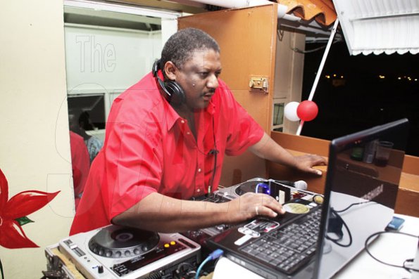 Anthony Minott/Freelance Photographer
Disc Jokey, Mikey Thompson of Kool 97 FM plays soul music during Ken's Wildflower Valentine's Night party atop the roof of Ken's Wildflower Restaurant and Lounge, Port Henderson Road, Portmore Plaza, Tuesday, February 14, 2012.