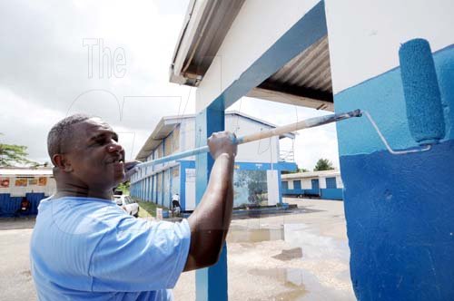 Ricardo Makyn/Staff Photographer
Mark Hamilton, a member of the Linstead and Bog Walk Taxi Association, paints a section of the Linstead Primary and Junior High School in St Catherine on Monday, Labour Day.

 May  on Monday 25.5.2009.