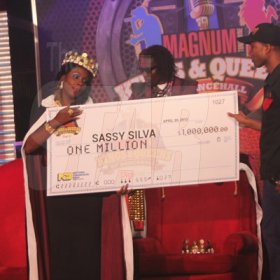 Anthony Minott/Freelance Photographer
Sassy Silver (left), collects her $1 Million dollar cheque from Chrisna Benson, Brand Manager of Magnum Tonic Wine after he was crowned the the Magnum Kings of Dancehall 2013 during the Magnum Kings and Queens of Dancehall final live show at D'Entrance, Constant Spring Road, St Andrew on Saturday night.