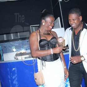 Anthony MInott/Freelance Photographer
Popular Photographer, Johnny British (right), accepts his award from a female presenter, for best photographer during a Magnum Portmore Dancehall Awards function at Club NTyce, Naggo Head, Portmore, St Catherine last Saturday.