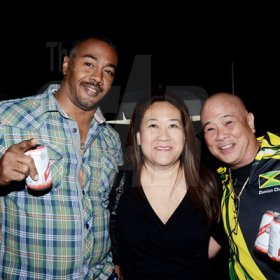 Winston Sill/Freelance Photographer
The Red Stripe sponsored Major Lazer Party and Show, held at Caymanas Estate, St. Catherine on Friday night December 19, 2014.

Three's Company: Damian Chung (right) joins in with Julian Walker and Simone Chanpong (middle) for a quick photo op