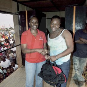 Contributed

The Gleaner's Shernett Reid (left) presents a winner with her prize.