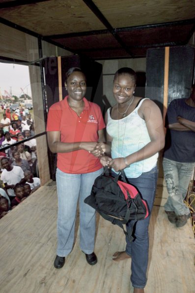 Contributed

The Gleaner's Shernett Reid (left) presents a winner with her prize.