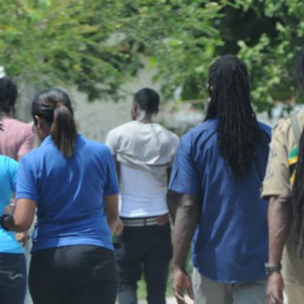 Jermaine Barnaby/Freelance Photographer
Members of the Peace Management Initiative (PMI) among other community members in the March Pen road on Monday October 10, 2016.