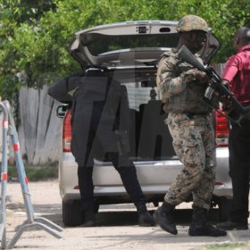 Jermaine Barnaby/Freelance Photographer
Police carrying out a check on a vehicle entering the March Pen road area on Monday October 10, 2016.