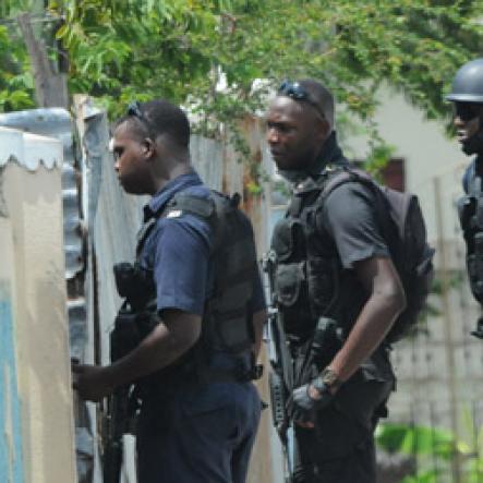 Jermaine Barnaby/Freelance Photographer
Police carrying out house and home checks in the March Pen road area on Monday October 10, 2016.