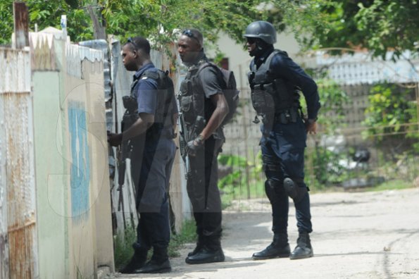 Jermaine Barnaby/Freelance Photographer
Police carrying out house and home checks in the March Pen road area on Monday October 10, 2016.