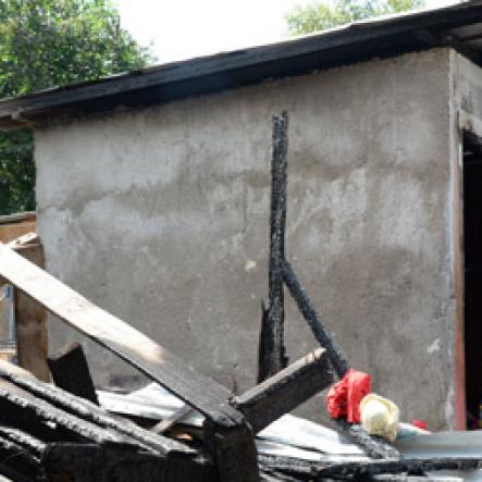 Jermaine Barnaby/Freelance Photographer
One of the houses that was set ablaze allegedly by the gunmen in March Pen road shooting on Monday October 10, 2016.