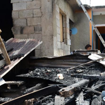 Jermaine Barnaby/Freelance Photographer
One of the houses that was set ablaze allegedly by the gunmen in March Pen road shooting on Monday October 10, 2016.