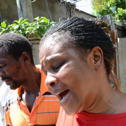 Rudolph Brown/Photographer
Jennifer McDonald, (centre) Mother and grandmother mourning the death of family after gunmen shoot up seven killing five including three children and set their home ablaze at Africa settlement in March Pen Community in Spanish Town on Sunday, October 9