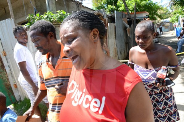 Rudolph Brown/Photographer
Jennifer McDonald, (centre) Mother and grandmother mourning the death of family after gunmen shoot up seven killing five including three children and set their home ablaze at Africa settlement in March Pen Community in Spanish Town on Sunday, October 9