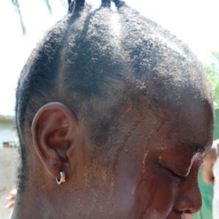 Rudolph Brown/Photographer
Family members mourning the death of family after gunmen shoot up seven killing five including three children and set their home ablaze at Africa settlement in March Pen Community in Spanish Town on Sunday, October 9