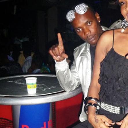 Roxroy McLean photo                                                                                                                                                 Dancehall artiste Flexxx and a female companion hang out at the 'Real McKoy' party.