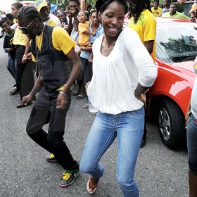 Ian Allen/Photographer
400 metre World Championship winner Melanie Walker and her brother dance up a storm on her arrival on Maxfield Avenue on tuesday.