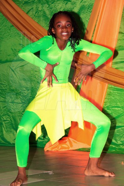 Anthony Minott/Freelance Photographer
 Newly crowned, Mini Miss Portmore 2010, Kadecia Briscoe (Miss Sea Horse Rider Hotel), a student from the Southborough Primary School, dances during a Mini Miss Portmore 2010 grand coronation show at the Portmore HEART Academy on Saturday, May 22, 2010.