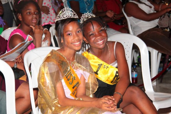 Anthony Minott/Freelance Photographer
 Jenelle Baldie (left), last year's winner in the Mini Miss Portmore pageant shares a moment with Sanique Brown, last year's first runner up, during a Mini Miss Portmore 2010 grand coronation show at the Portmore HEART Academy on Saturday, May 22, 2010.