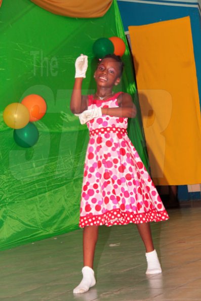 Anthony Minott/Freelance Photographer
Audrene Cameron, sign language to 'My redeemer' during a Mini Miss Portmore 2010 grand coronation show at the Portmore HEART Academy on Saturday, May 22, 2010.