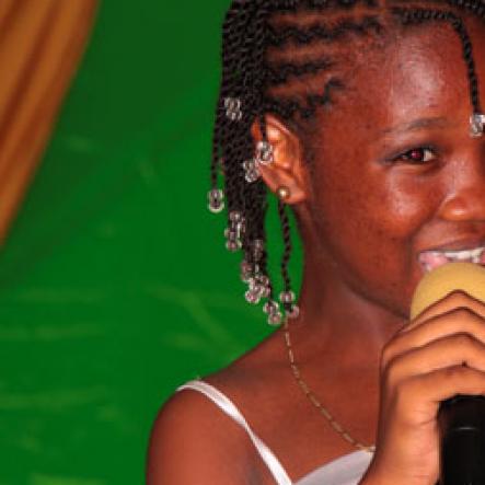 Anthony Minott/Freelance Photographer
Guest performer, Sanique  Brown, last year's first runner up performs  a poem, "Roast turkey' during a Mini Miss Portmore 2010 grand coronation show at the Portmore HEART Academy on Saturday, May 22, 2010.