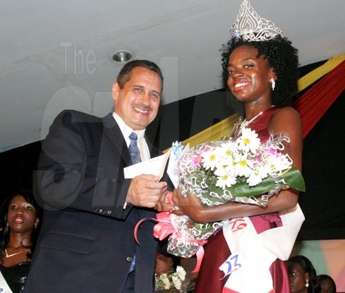 Anthony Minott/Freelance Photographer
Paul Abrahams (left), Managing Director of the Jamaica Urban Transit Company (JUTC) hands over a smart card prize value at $5,000 to ride on JUTC buses to newly crowned, Miss Teen Portmore Michelle Cole during a Burger King/Jamaica Money Market Brokers (JMMB), Miss Teen Portmore pageant at the Portmore HEART Academy on Sunday, August 23, 2009. Michelle Cole, wearing the sash, Ken's Wildflower walked away with the coveted crown. 24 girls contested the pageant which was in tribute of the late pop icon Michael Jackson.