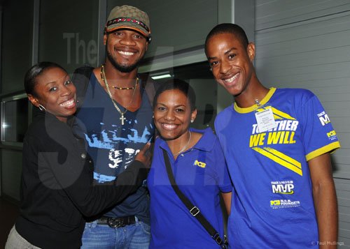 Contributed
Shericka Williams (left), 400 metres silver medallist and Asafa Powell (second left) 100 metres bronze medallist are happily greeted by Tishan Lee, NCB senior corporate communications officer and Christopher Vendryes, NCB Foundation?s sports co-ordinator after their arrival last Saturday at the Norman Manley International Airport, Kingston.