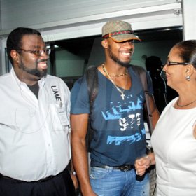 Contributed
LIME?s vice president, marketing, Wayne Lawrence (left) and Minister of State in the Office of the Prime Minister, Shahine Robinson (right) were among the delegation that greeted World 100M bronze medalist, Asafa Powell at the Norman Manley International Airport.  Asafa, World and Olympic 400M Silver Medalist, Shericka Williams and 100M hurdles World Champion, Brigette Foster-Hilton returned to the island on Saturday.